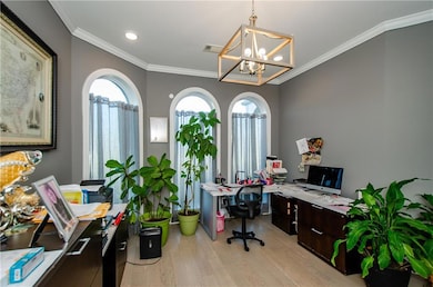 Home office featuring light wood-style flooring, a chandelier, crown molding, and recessed lighting