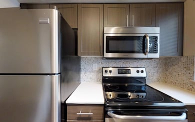 Kitchen featuring decorative backsplash and stainl