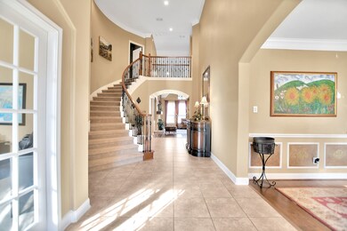 View of the grand staircase and foyer from the front entrance (dining room to right, office to left)