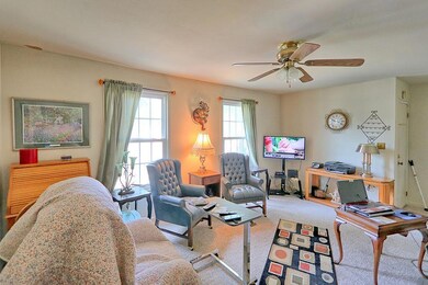 Living room is spacious with Berber-style carpeting.