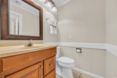 Bathroom featuring vanity, toilet, and tile patter