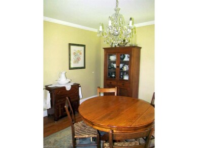 Formal dining room with crown molding and hardwood