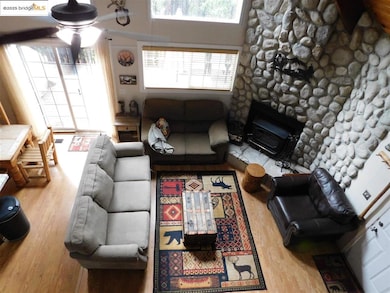 Living room featuring ceiling fan and hardwood / wood-style floors