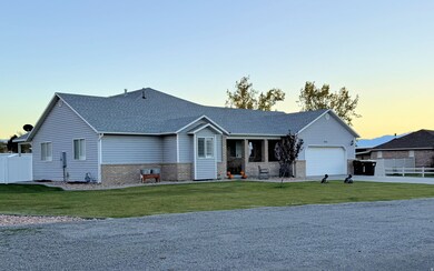 View of front of house featuring brick siding, a porch, roof with shingles, an attached garage, and driveway