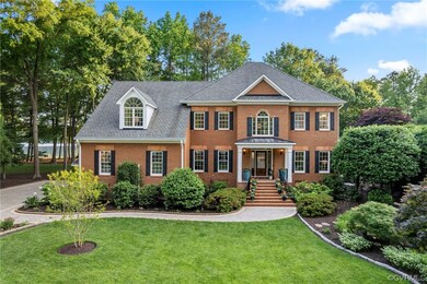 Front exterior. Nicolock driveway and front entrance with pathway lighting. Landscaping. Note view to the left allowing water views even when you pull into the driveway and garage.
