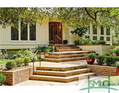 Exterior Front. The brick stairway, lush landscapi