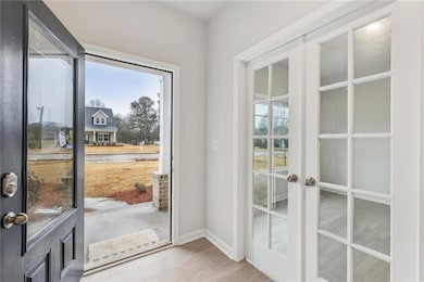Entryway with french doors, wood finished floors, 