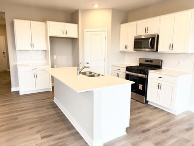 Photo of Actual Home: This home includes Hardware, backsplash, and soft close doors.