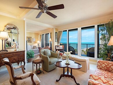 Tiled living room with ceiling fan, crown molding,