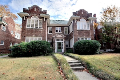 View of front of house with brick siding and a front lawn