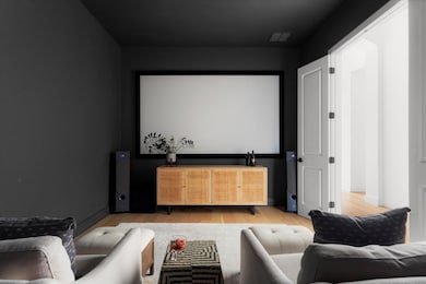 Home theater featuring wood finished floors