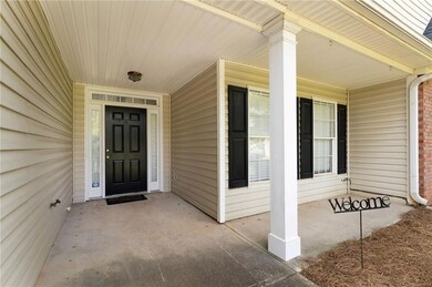View of exterior entry featuring covered porch