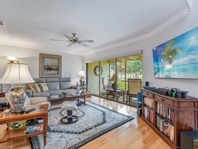 Living area with crown molding, light wood-style floors, and a ceiling fan