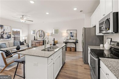 Kitchen with refrigerator, a sink, decorative backsplash, white cabinets, and recessed lighting