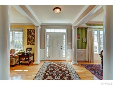 Welcoming wide open foyer with hardwood floor, han