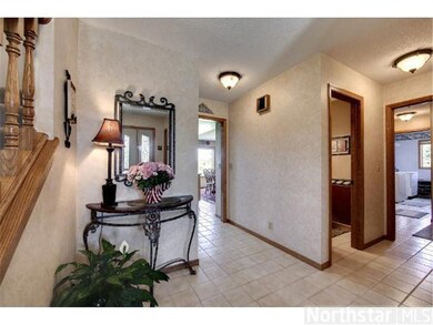 Ceramic foyer with double coat closet.  A hallway 