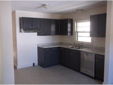 New kitchen with dishwasher and tile floors.