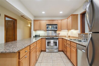 Kitchen has wood cabinets and granite counter tops