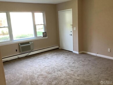 Living room with main entrance, new carpeting and freshly painted.