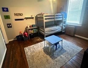 Bedroom featuring dark wood finished floors and ceiling fan