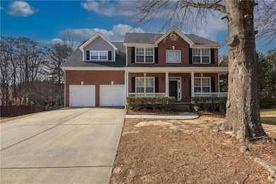 Colonial inspired home featuring brick siding, a p
