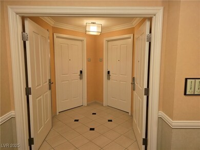 Doorway featuring crown molding and light tile pat