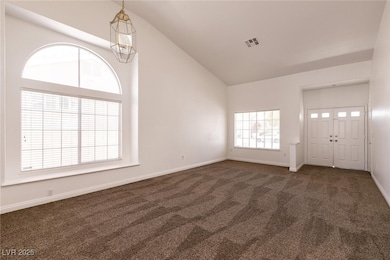 Entrance foyer with baseboards, visible vents, car