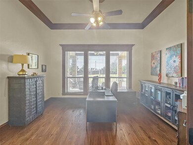 Sitting room featuring ceiling fan and wood finish