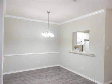 Unfurnished room featuring crown molding, baseboar