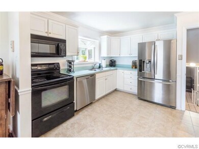 Nicely updated kitchen crisp white cabinetry, clea