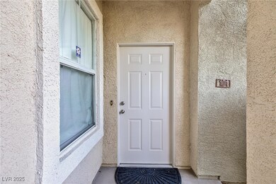 Doorway to property featuring stucco siding