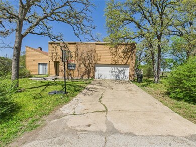 View of front of property with driveway, a front y
