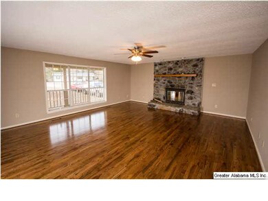 LARGE FAMILY ROOM WITH WOOD BURNING FIREPLACE.