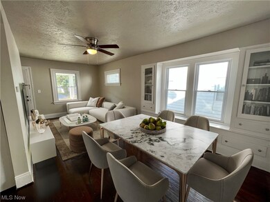 Dining area featuring dark hardwood / wood-style flooring, a textured ceiling, and ceiling fan