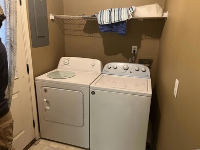 Laundry room with electric panel and washer and dr