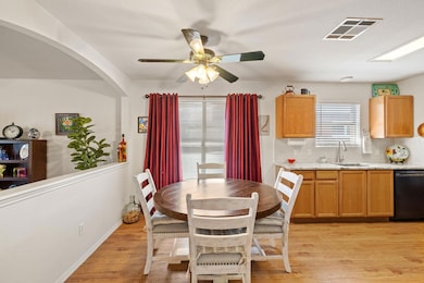Dining room with a ceiling fan, arched walkways, 