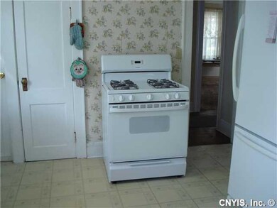 Kitchen stove & fridge to R - doorway to hall and 