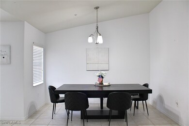 Dining area with baseboards and light tile pattern