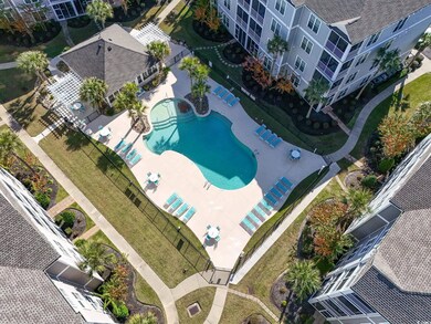 Aerial view of a pool area and apartment complex / building