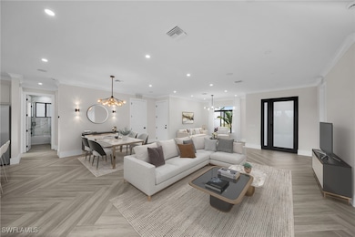 Living room featuring a chandelier, ornamental mol