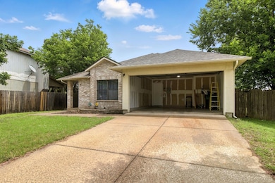 View of front of home with concrete driveway, a g