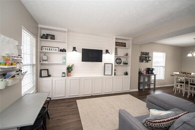 Living room with charming build-in bookshelves and storage!!