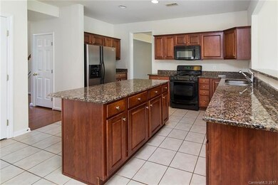 Open Kitchen offers island, granite countertops, c