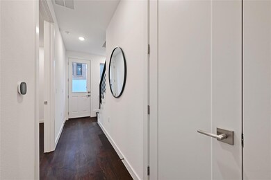 Hall with visible vents, baseboards, recessed lig