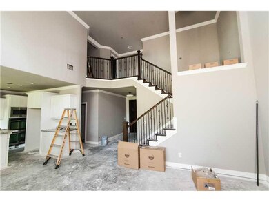 Living Room. Elegant wrought iron staircase, open living area.