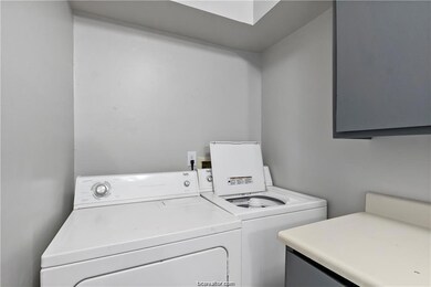 Laundry area featuring washing machine and clothes