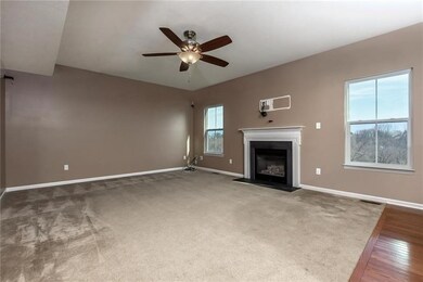 The Family Room is Light and Bright with a Gas Fir