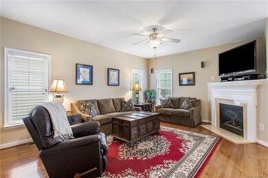 Large family room with hardwood floors, lovely gas fireplace and mantle.