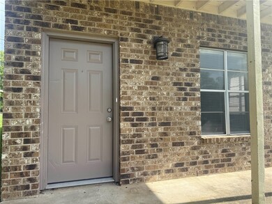 Doorway to property with brick siding