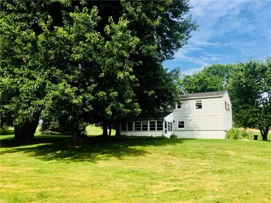 The rear of the home shows the 3 season room, walk